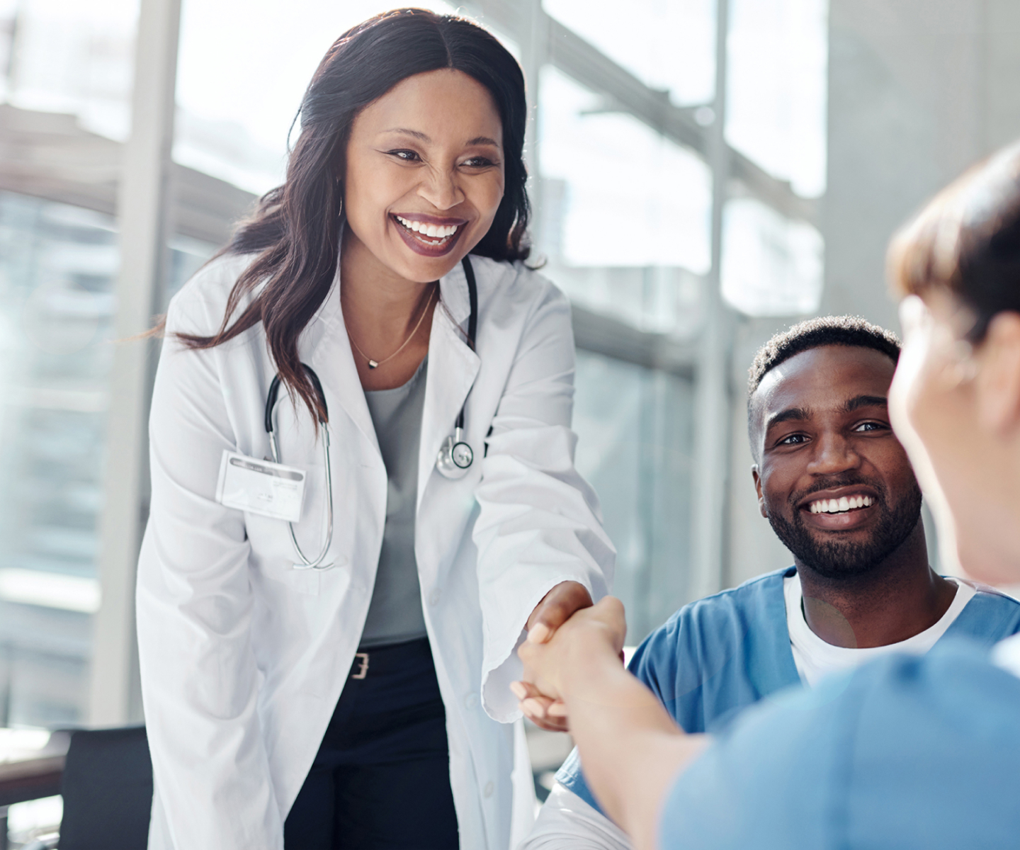 Doctor shaking hands with another doctor